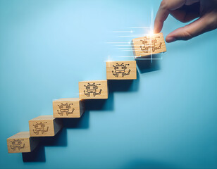 A person's hand places the final wooden block with an anchor icon onto a staircase of blocks, signifying progress and goal achievement
