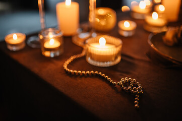 Candlelight date in restaurant. Table setting for couple, Valentine's Day evening, burning candles for surprise marriage proposal. Romantic dinner setup at night.