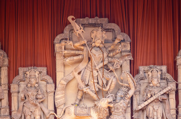 A beautifully crafted handmade colorful goddess durga idol decorated for Navratri, featuring vibrant traditional attire, intricate jewellery, and divine expressions at colorful pandal.