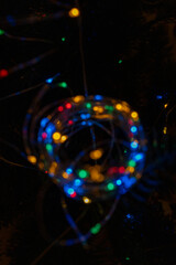 Colorful bokeh LED fairy lights on dark background
