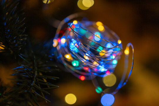 Colorful bokeh LED fairy lights on dark background - Powered by Adobe