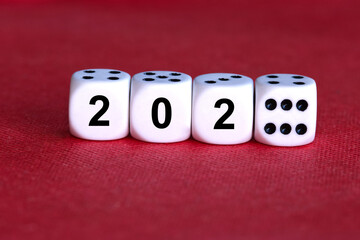 The inscription “2026” on a die, with “202” written as Arabic numerals and the final “6” shown as the dots on the dice, placed against a red background.