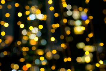 Blurry holiday background with yellow bubbles bokeh.
