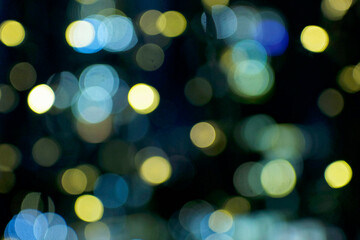 Blurry holiday background at night with blue colored. Bubbles bokeh.
