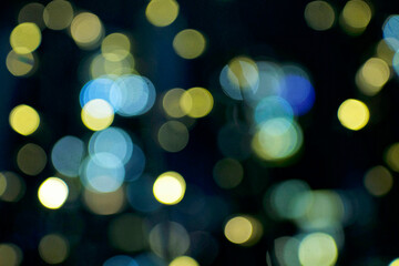 Blurry holiday background at night with blue colored. Bubbles bokeh.