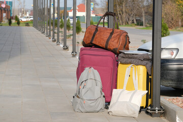  suitcases and bags on parking lot near car. Concept of travel and transportation