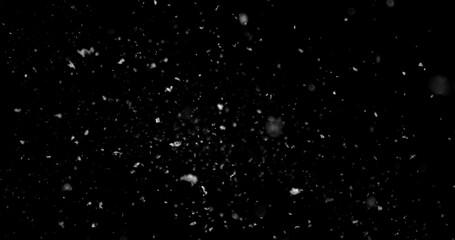 Obraz premium Falling snowflakes isolated on black background. Winter snow overlay texture for VFX, compositing, motion graphics and atmospheric effects