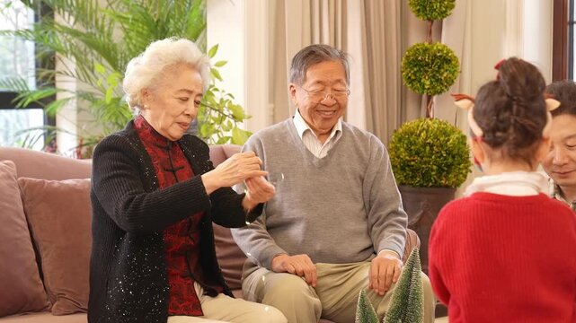 Family hanging Christmas ornaments and string lights