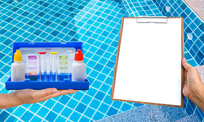Swimming pool water testing test kit with blank report paper on wooden clipboard over clear pool...