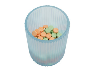 Isolated transparent cup filled with multicolored pills for medical treatment concept