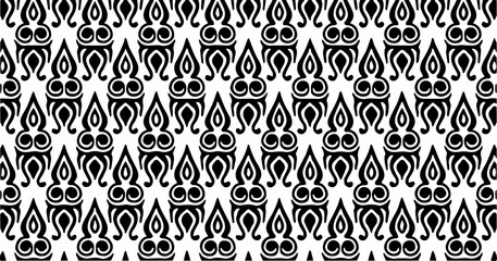 Black and white ethnic-style pattern with repeating flame-like and teardrop shapes arranged symmetrically.