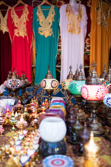 Vibrant Moroccan Market Stall with Handmade Bags and Colorful Lamps.