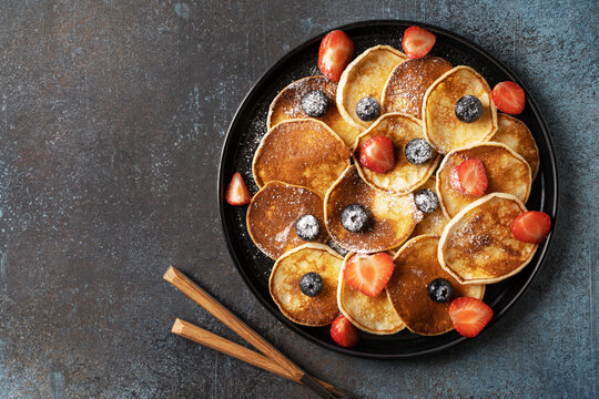 Mini pancakes with blueberries and strawberries