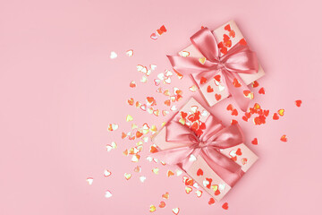 Bright pink heart shape confetti and gift box
