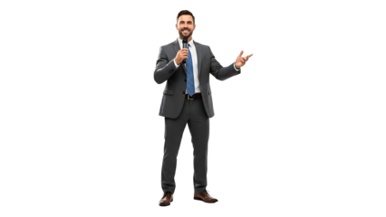 A business professional confidently addressing an audience while holding a microphone and gesturing with his hand. He is wearing a formal suit and smiling confidently.