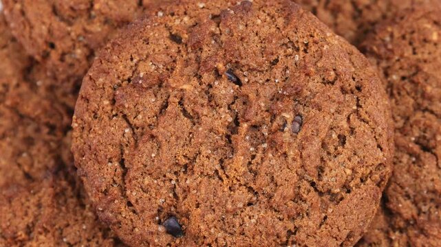Brown oatmeal cookies with chocolate chips circle rotation close up