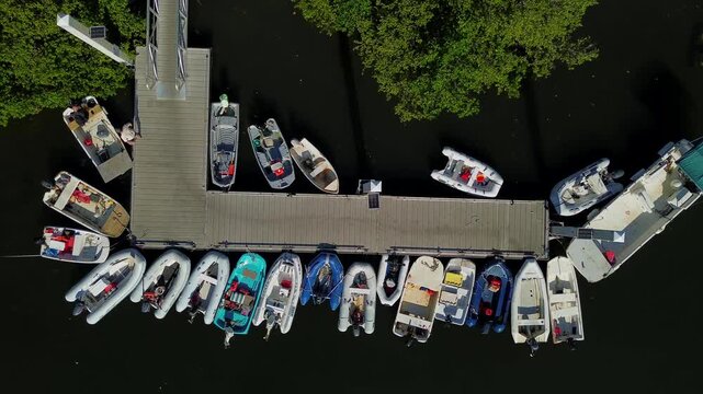 aerial shot of a bunch of dinghies in marina dock