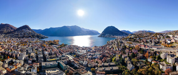 Lugano city aerial view with Lake Lugano and surrounding mountains. Lugano, Canton of Ticino, Switzerland.