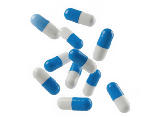 Scattered blue and white capsules isolated on transparent background