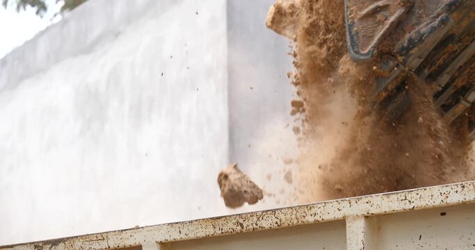 Backhoe excavator digging soil at construction site, backhoe digging soil for trucks