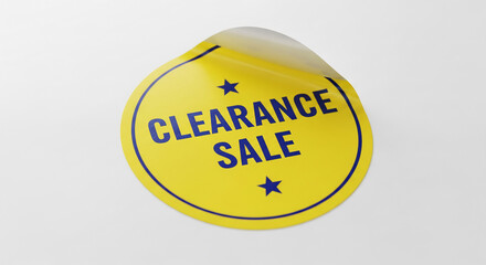 A yellow round sticker with blue text "Clearance Sale", partially peeled from a white surface, suggesting discounts and retail promotions