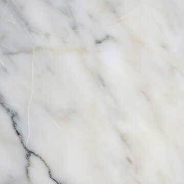 Close-up of white marble texture with natural veins and subtle gray and beige patterning used for backgrounds or interior surfaces