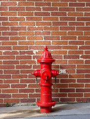 Fire Hydrant Against Brick Wall Background. 