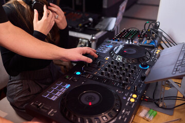 DJ setup overview, Energetic club DJ performing with digital controller in action, Content creator mixing music live using digital turntables under vibrant stage lights