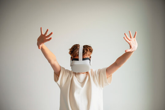 teenager playing with virtual reality glasses - Powered by Adobe