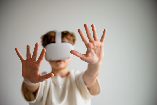 teenager playing with virtual reality glasses - Powered by Adobe