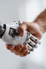 Close up of human and robotic hand firm handshake symbolizing partnership