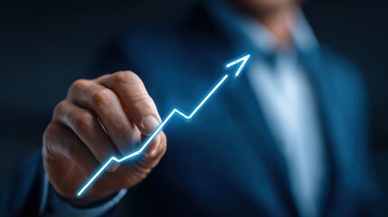 Businessman holding glowing arrow graph representing business growth, financial success, progress, and future strategy