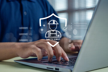 Digital safety management concept showing worker protection icons above hands typing on a laptop, highlighting workplace safety, risk prevention, compliance, and secure operational practices.