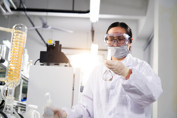 Asian female scientist conducts experiments in laboratory