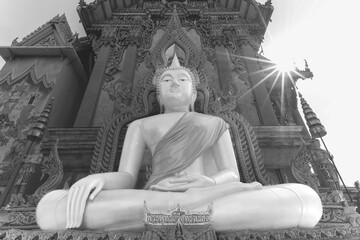 Buddha statue with tunic, Bhumispara mudra, Buddha Gautama at the moment of enlightenment, at the entrance to Wat Sitthawararam, Bangkok, Thailand
