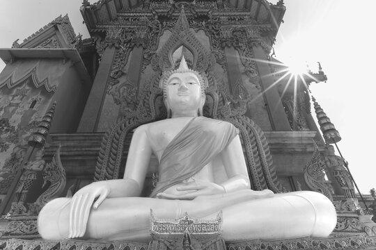 Buddha statue with tunic, Bhumispara mudra, Buddha Gautama at the moment of enlightenment, at the entrance to Wat Sitthawararam, Bangkok, Thailand