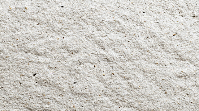 A textured light gray stone surface with tiny imperfections. The rough and uneven texture creates an interesting visual