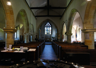 Atmospheric View Down the Nave of St. Bartholomew's Church with Stained Glass
