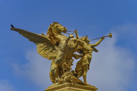 Column with the group of figures Fama of War on the Pont Alexandre III bridge over the Seine, Paris, France
