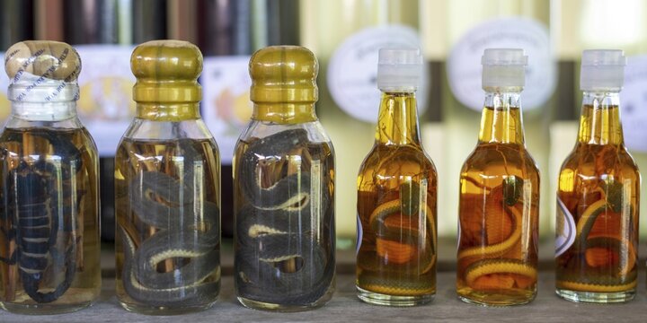 Choum, rice liquor, rice wine with pickled scorpions and Snakes for sale, Laos