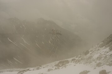 Cable car technicians working in bad weather conditions, Nebelhorn cable car near Oberstdorf, Allgäu Alps, Allgäu, Bavaria, Germany