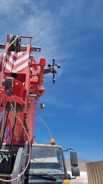 Crane parked with an anemometer measuring wind speed in the desert.