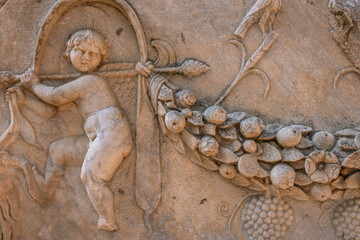 An ancient bas-relief on a marble surface. Antique carvings depicting fabulous creatures. the surface of the stone. Ancient Greek myths in marble. Ruins of an ancient city.