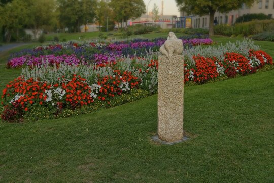 The sculpture Venus of Amberg surrounded by a colourful flower bed in the municipal park, Amberg, Upper Palatinate, Bavaria, Germany