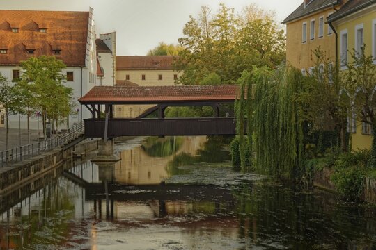 The old ship bridge leads over the calm river Vils with reflection in the water, Amberg, Upper Palatinate, Bavaria, Germany
