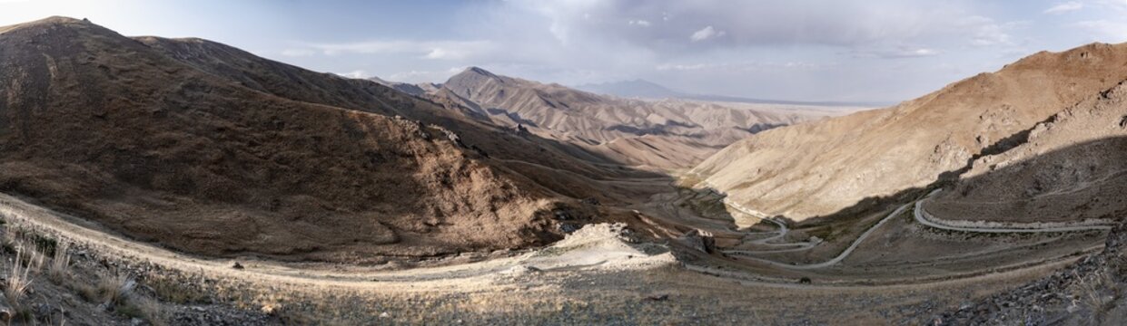Panorama, view of mountain landscape and pass road at Tyibel Pass, Song Kul Too mountain range, Naryn region, Kyrgyzstan