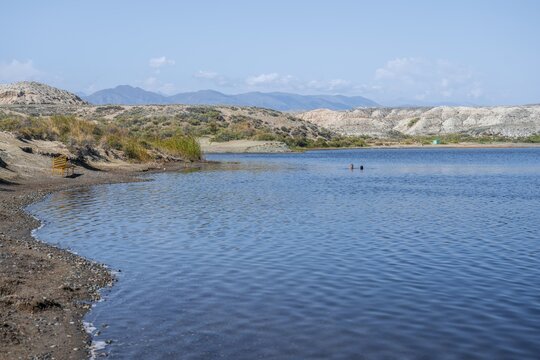 People bathing in the Tuz Kul salt lake, medicinal lake with high salt content, Issyk Kul, Kyrgyzstan