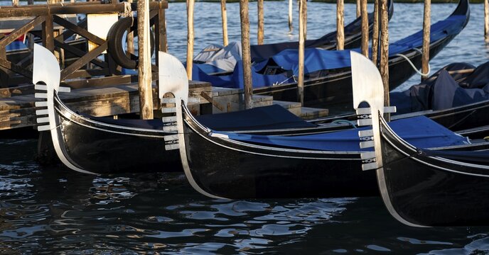 Bow fitting, Venetian gondolas, detail, jetty at St Mark's Square, evening light, Venice, Veneto, Italy
