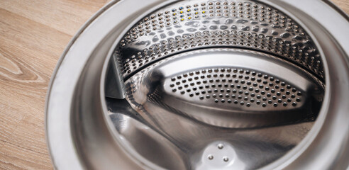 Washing machine drum prepared for repair, showing appliance maintenance and service work.