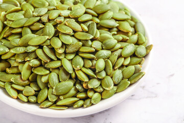 Roasted Pumpkin Seeds in White Bowl - Healthy Snack Studio Shot